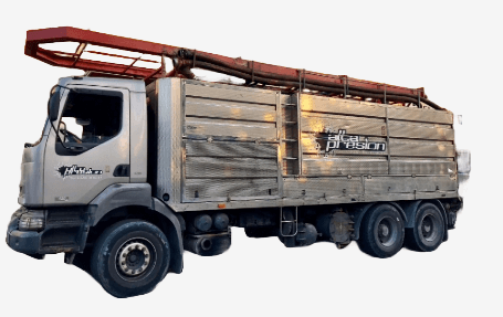 Foto de un camión cisterna con el logotipo de la empresa, que está realizando un servicio de transporte de residuos de un separador de grasas en una calle de Estepona